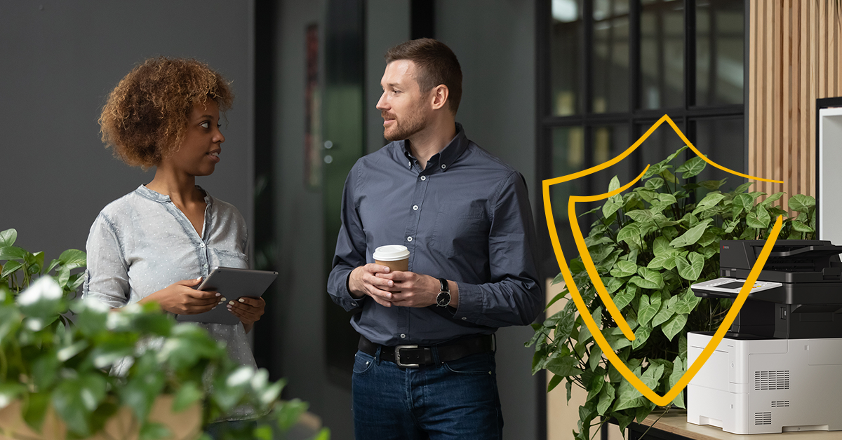 Two collogues talking to each other next to an ecosys device