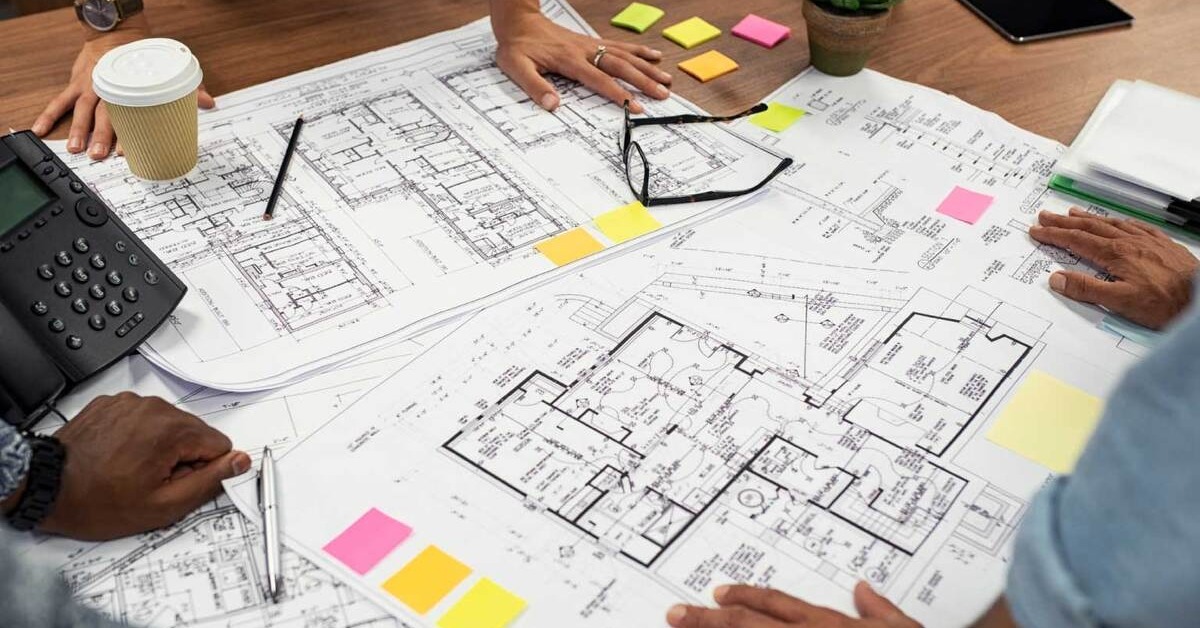 3 people looking at the blueprint