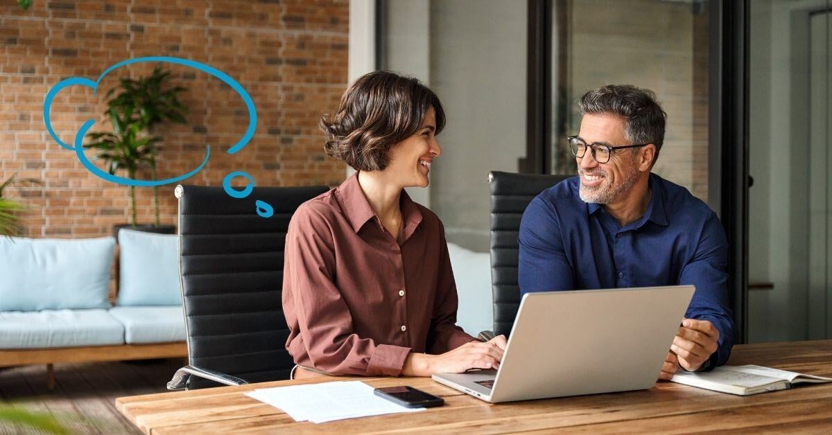 Two people chat in front of a laptop, with a blue thought cloud overlaid