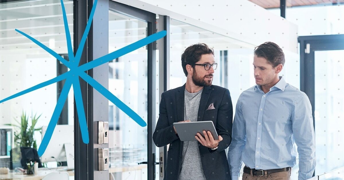Two business professionals walking in a modern office